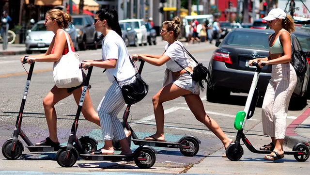 People Driving Aniv Scooters