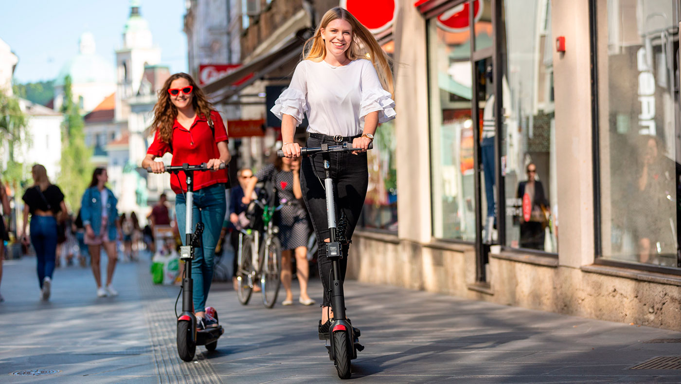 girls riding electric scooters
